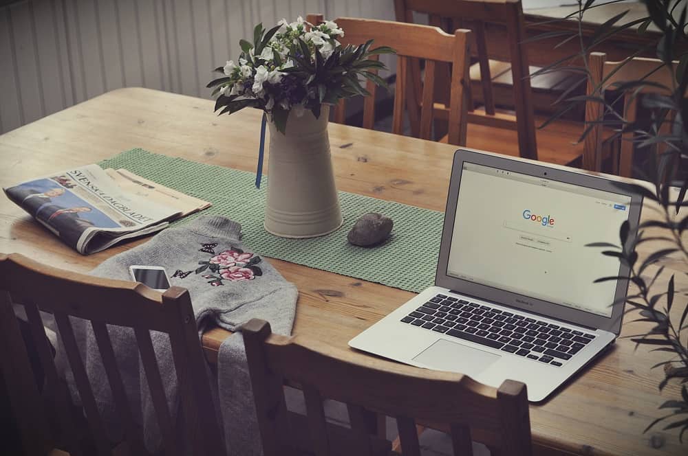 Laptop on a livingroom table with Google on the screen